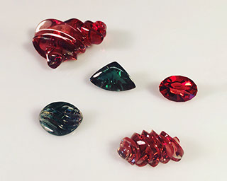 Assorted Oregon Sunstone Carvings by Aaron Sangennito